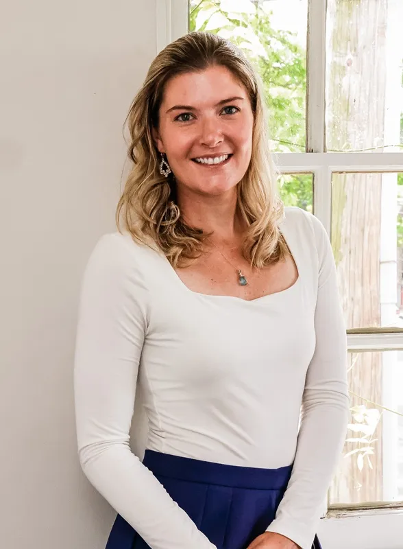 Photo of Dr. Carolyn Dominica inf front of a window